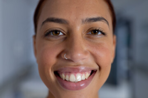 Straight girl with nose piercing looking confident and stylish