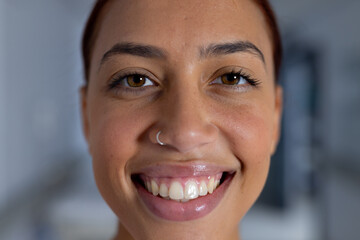 Straight girl with nose piercing looking confident and stylish