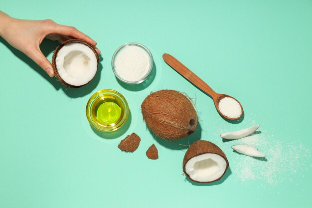 Bottle of coconut oil next to hair care products for enhancing growth and thickness